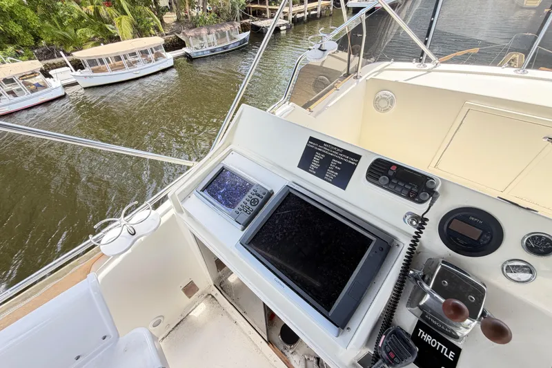 Slide: The Image of 1978 Hatteras 53 Motor Yacht helm with navigation equipment and throttle controls. - 40