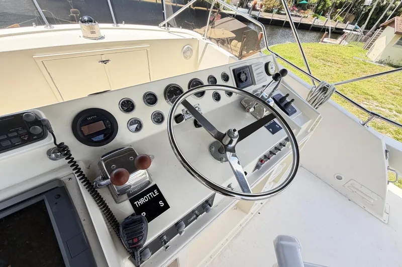 Slide: The Image of 1978 Hatteras 53 Motor Yacht helm with steering wheel and control panel. - 42