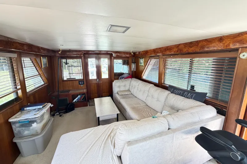 Slide: The Image of Interior of 1978 Hatteras 53 Motor Yacht with cozy seating and wooden accents. - 6