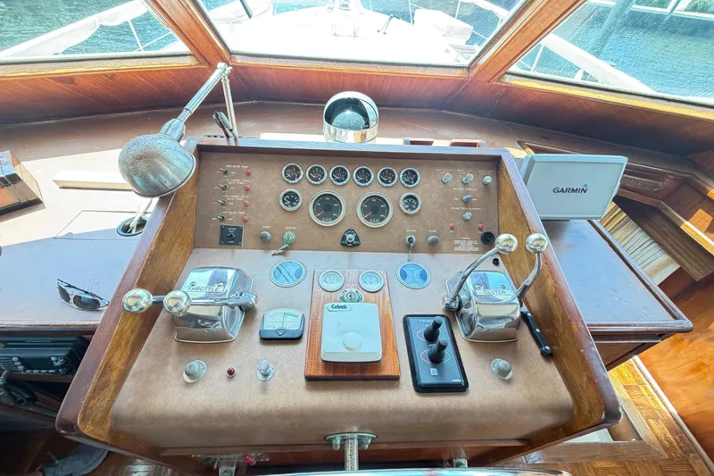 Slide: The Image of Helm of 1978 Hatteras 53 Motor Yacht with gauges, controls, and Garmin navigation system. - 7