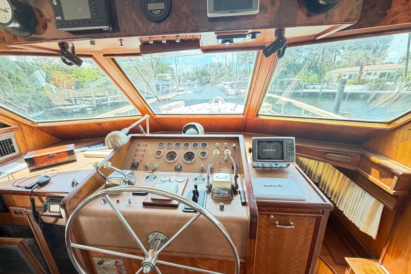 Slide: The Image of 1978 Hatteras 53 Motor Yacht helm with vintage controls and modern Garmin navigation. - 8