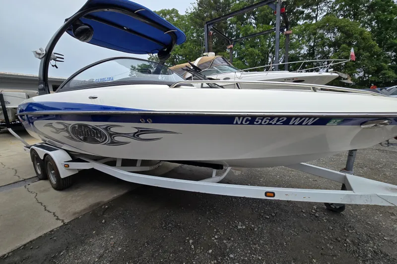 Slide: The Image of 2004 Malibu Wakesetter 23 LSV boat on trailer, featuring sleek design and graphics. - 1