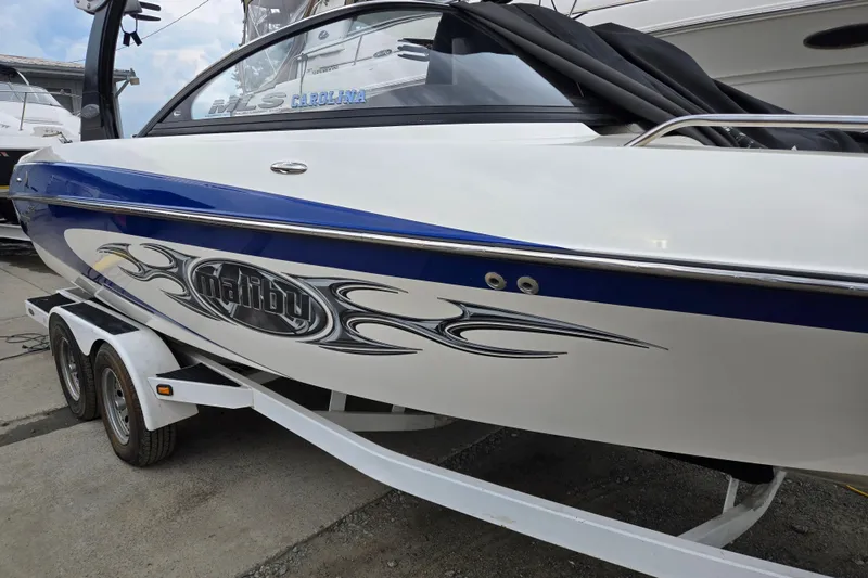 Slide: The Image of 2004 Malibu Wakesetter 23 LSV boat on trailer, featuring sleek design and graphics. - 10