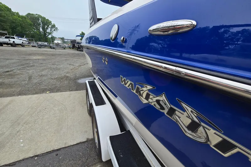 Slide: The Image of 2004 Malibu Wakesetter 23 LSV boat in a parking area, close-up view. - 11