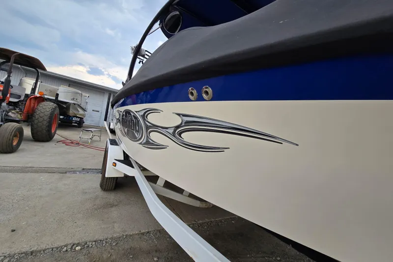 Slide: The Image of 2004 Malibu Wakesetter 23 LSV boat with custom graphics on a trailer. - 12