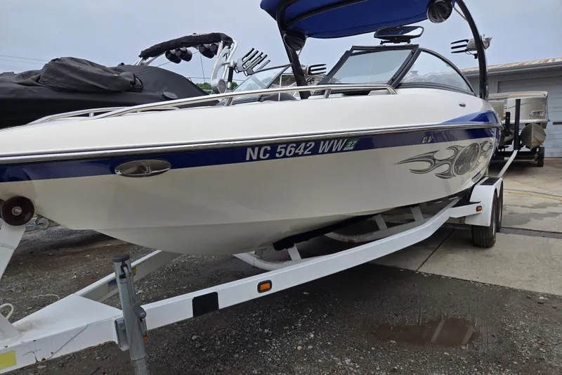 Slide: The Image of 2004 Malibu Wakesetter 23 LSV boat on trailer, featuring sleek design and graphics. - 13