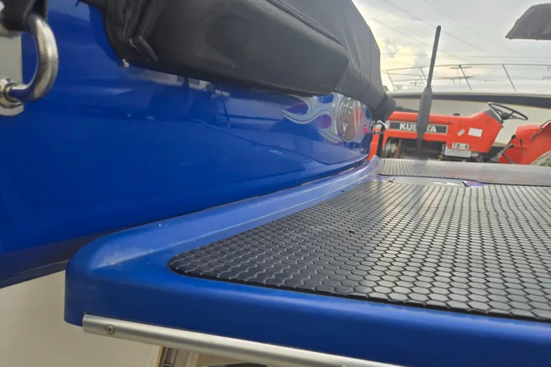Slide: The Image of 2004 Malibu Wakesetter 23 LSV boat with blue hull and textured deck surface. - 16