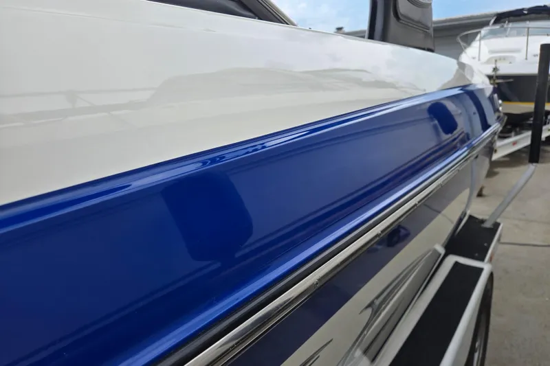 Slide: The Image of 2004 Malibu Wakesetter 23 LSV boat with sleek blue and white exterior detailing. - 19
