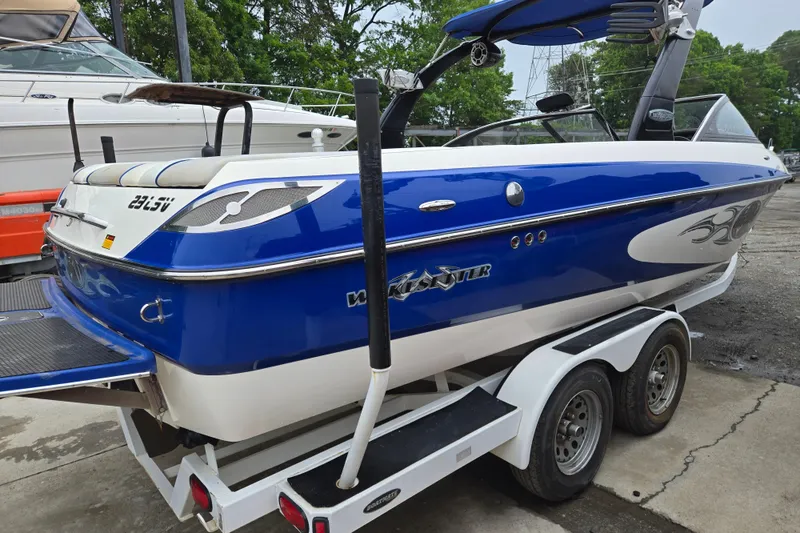 Slide: The Image of 2004 Malibu Wakesetter 23 LSV boat on trailer, blue and white design. - 2