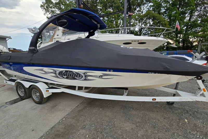 Slide: The Image of 2004 Malibu Wakesetter 23 LSV boat on trailer, covered, parked outdoors. - 21