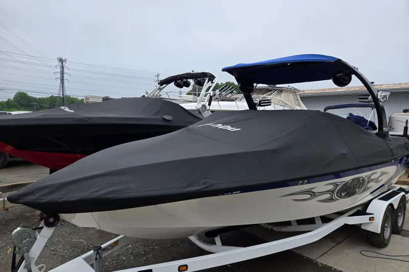 Slide: The Image of 2004 Malibu Wakesetter 23 LSV boat covered, parked on a trailer. - 24