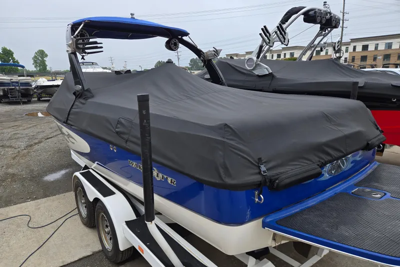 Slide: The Image of 2004 Malibu Wakesetter 23 LSV boat covered, on trailer, in a parking lot. - 25