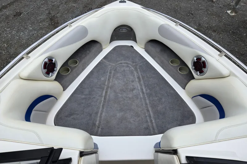 Slide: The Image of 2004 Malibu Wakesetter 23 LSV boat interior with cushioned seating and speakers. - 26