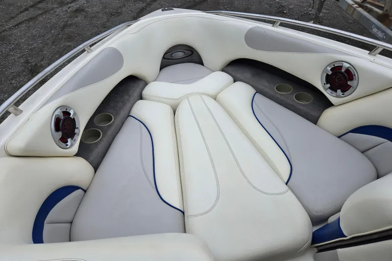 Slide: The Image of 2004 Malibu Wakesetter 23 LSV boat interior with white and blue seating. - 27