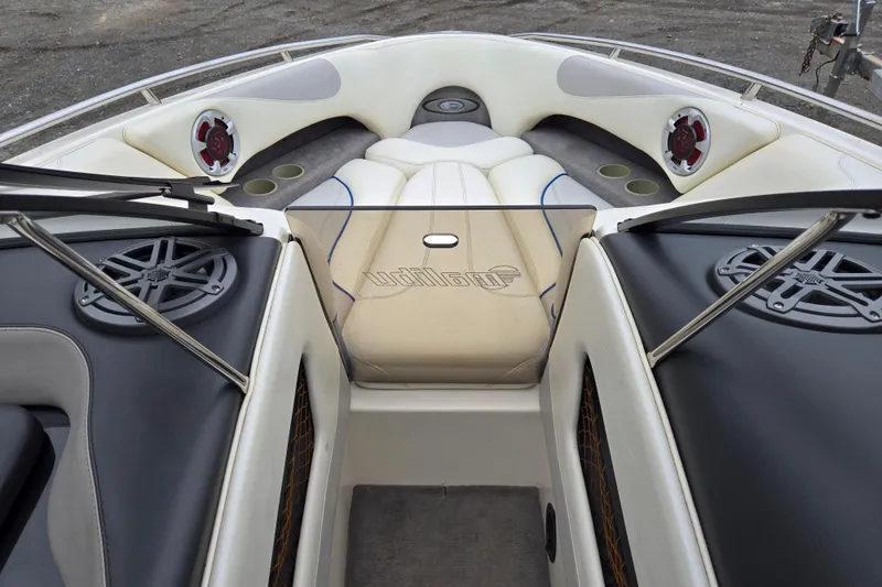 Slide: The Image of Interior view of a 2004 Malibu Wakesetter 23 LSV boat with speakers and seating. - 28