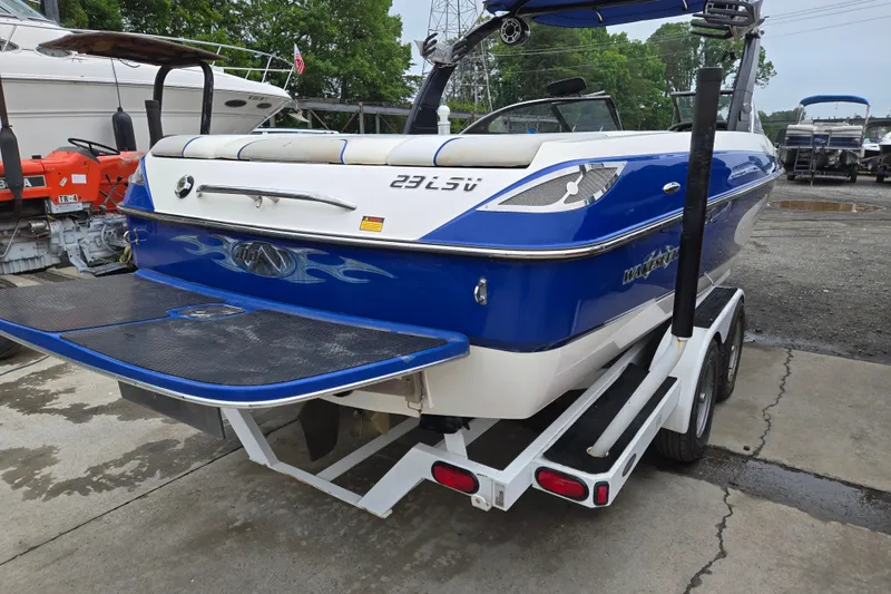 Slide: The Image of 2004 Malibu Wakesetter 23 LSV boat on trailer, blue and white design. - 3
