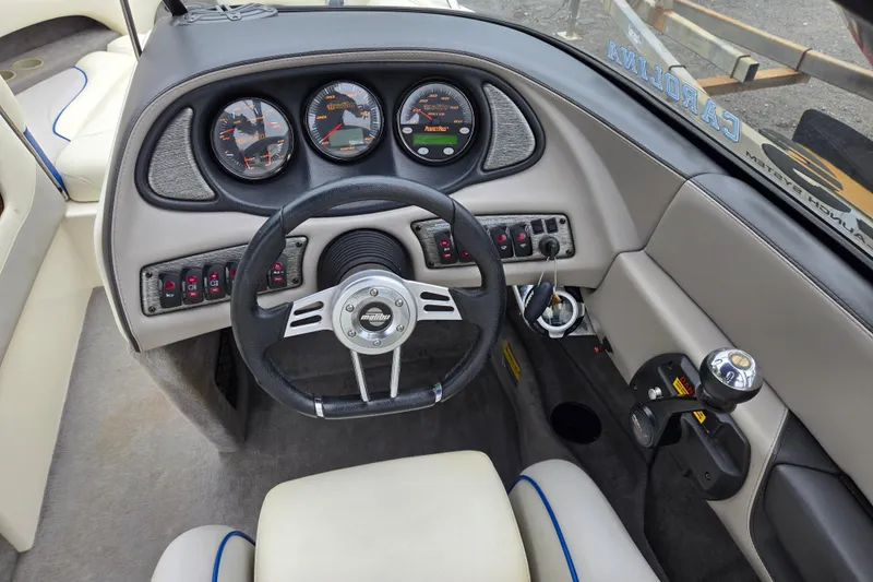 Slide: The Image of 2004 Malibu Wakesetter 23 LSV dashboard with steering wheel and control panel. - 31
