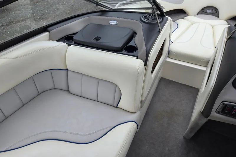 Slide: The Image of Interior of 2004 Malibu Wakesetter 23 LSV boat with white seating and storage compartments. - 32