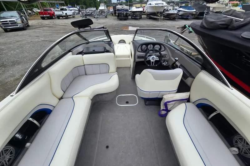 Slide: The Image of 2004 Malibu Wakesetter 23 LSV boat interior with seating and steering wheel. - 33