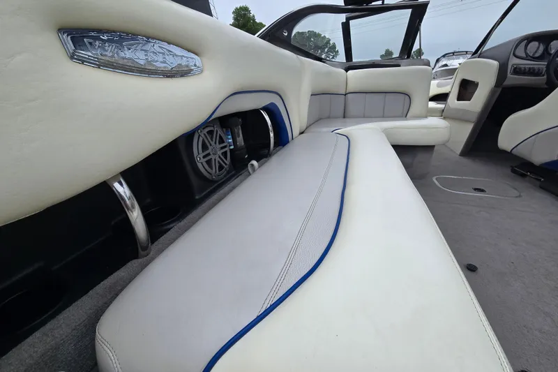 Slide: The Image of Interior of a 2004 Malibu Wakesetter 23 LSV boat with white seating and speaker system. - 34