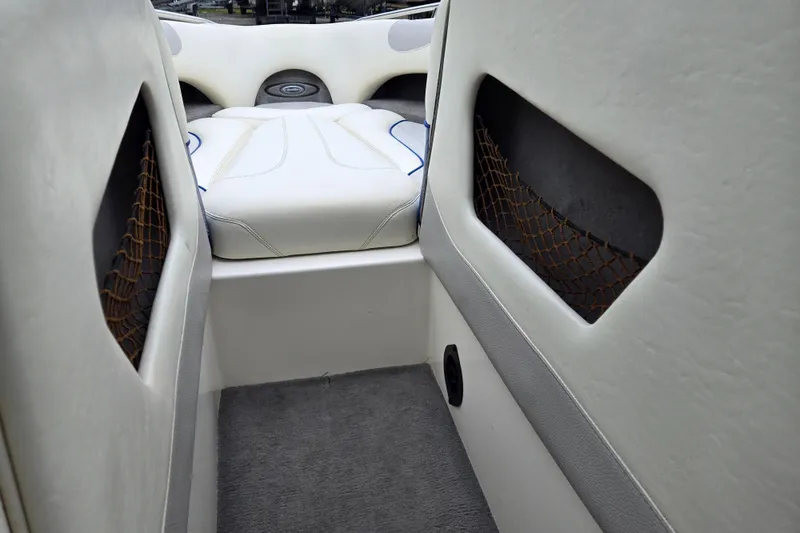 Slide: The Image of Interior of a 2004 Malibu Wakesetter 23 LSV boat with white seating and storage nets. - 40