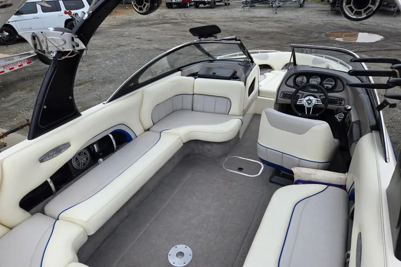 Slide: The Image of Interior of a 2004 Malibu Wakesetter 23 LSV boat with white seating and dashboard. - 41