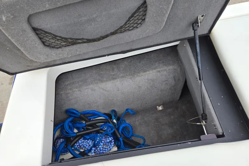 Slide: The Image of Open storage compartment in 2004 Malibu Wakesetter 23 LSV with blue ropes inside. - 43