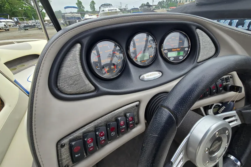 Slide: The Image of Dashboard of a 2004 Malibu Wakesetter 23 LSV boat with gauges and controls. - 52
