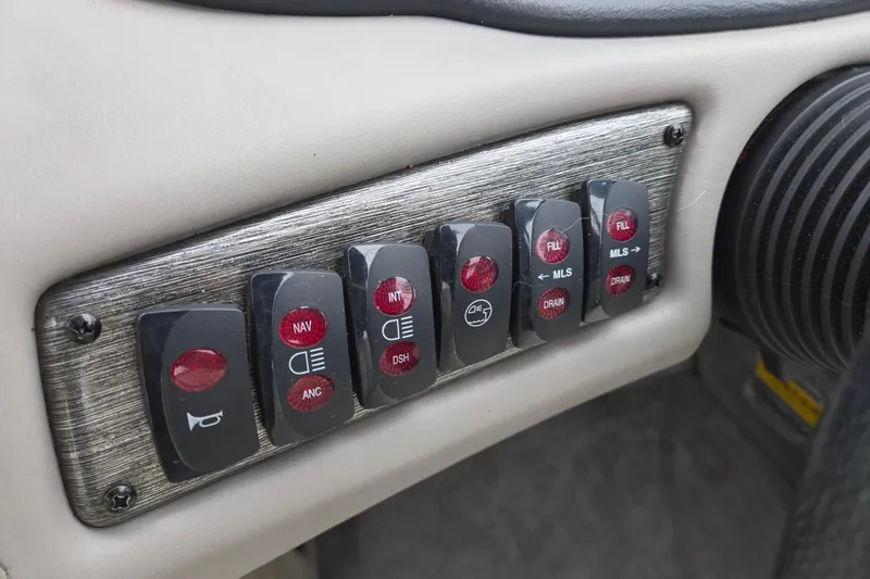 Slide: The Image of Dashboard switches of a 2004 Malibu Wakesetter 23 LSV boat. - 53