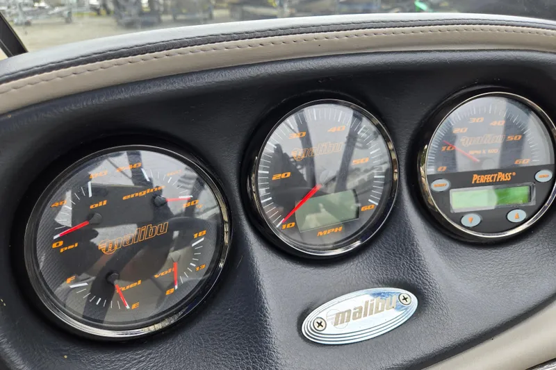 Slide: The Image of Dashboard of a 2004 Malibu Wakesetter 23 LSV with gauges and controls. - 54