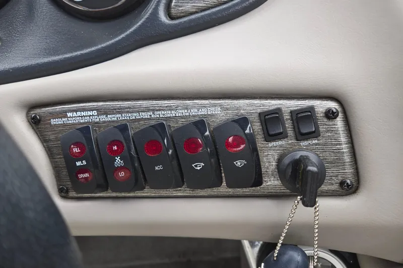Slide: The Image of Control panel of a 2004 Malibu Wakesetter 23 LSV boat with switches and ignition. - 55