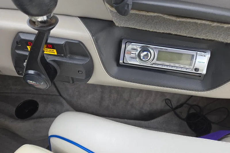 Slide: The Image of Boat dashboard with stereo system and throttle control in a 2004 Malibu Wakesetter 23 LSV. - 56
