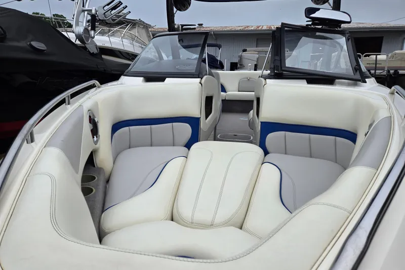 Slide: The Image of Interior of a 2004 Malibu Wakesetter 23 LSV boat with white and blue seating. - 57