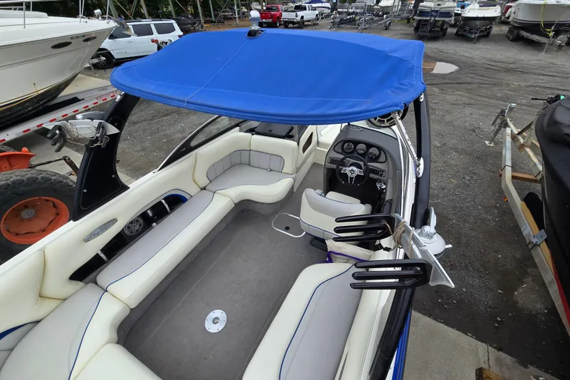 Slide: The Image of 2004 Malibu Wakesetter 23 LSV boat interior with blue canopy and seating. - 59