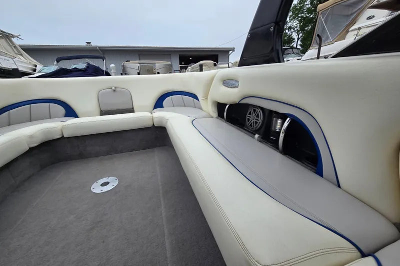 Slide: The Image of 2004 Malibu Wakesetter 23 LSV interior with white and blue seating, showcasing spacious design. - 60