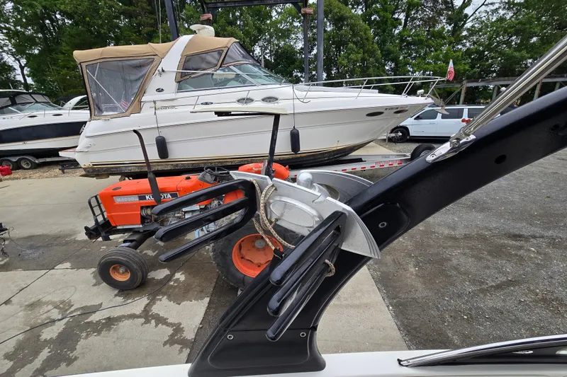 Slide: The Image of 2004 Malibu Wakesetter 23 LSV near docked boats and a Kubota tractor. - 61