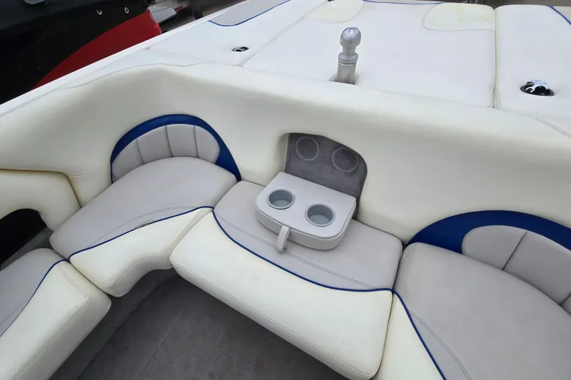 Slide: The Image of 2004 Malibu Wakesetter 23 LSV interior with white seating and cup holders. - 62
