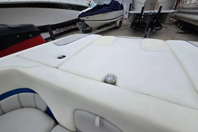 Slide: The Image of 2004 Malibu Wakesetter 23 LSV boat interior with white upholstery in storage. - 63