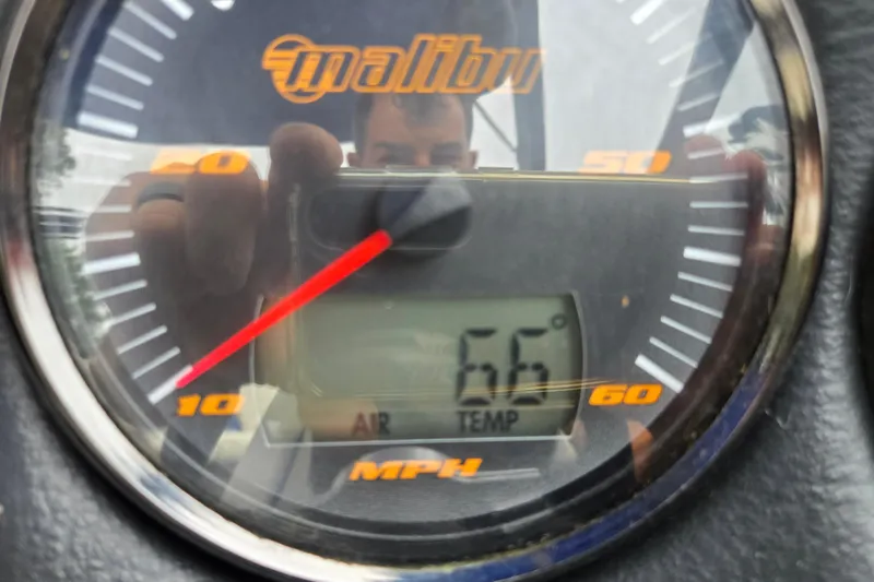 Slide: The Image of Close-up of a 2004 Malibu Wakesetter 23 LSV speedometer showing 66°F air temperature. - 64