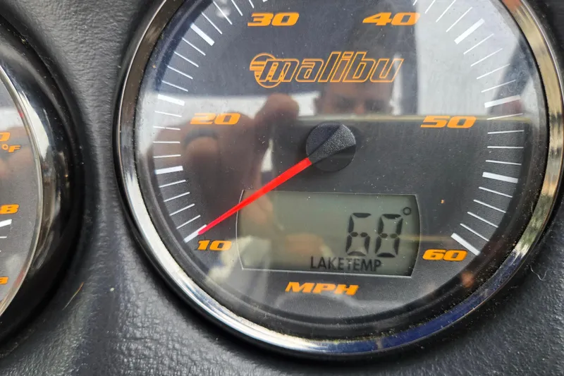 Slide: The Image of Close-up of a Malibu Wakesetter 23 LSV speedometer showing 60 MPH and lake temperature. - 65