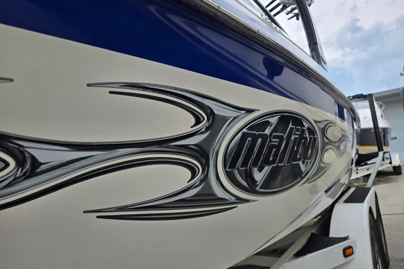 Slide: The Image of 2004 Malibu Wakesetter 23 LSV boat with sleek design and logo detailing. - 8