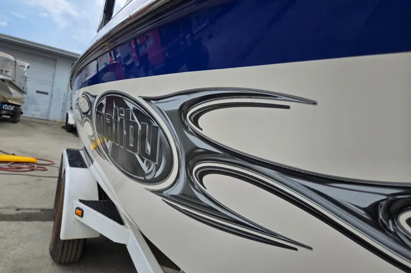 Slide: The Image of 2004 Malibu Wakesetter 23 LSV boat with sleek graphics on trailer. - 9