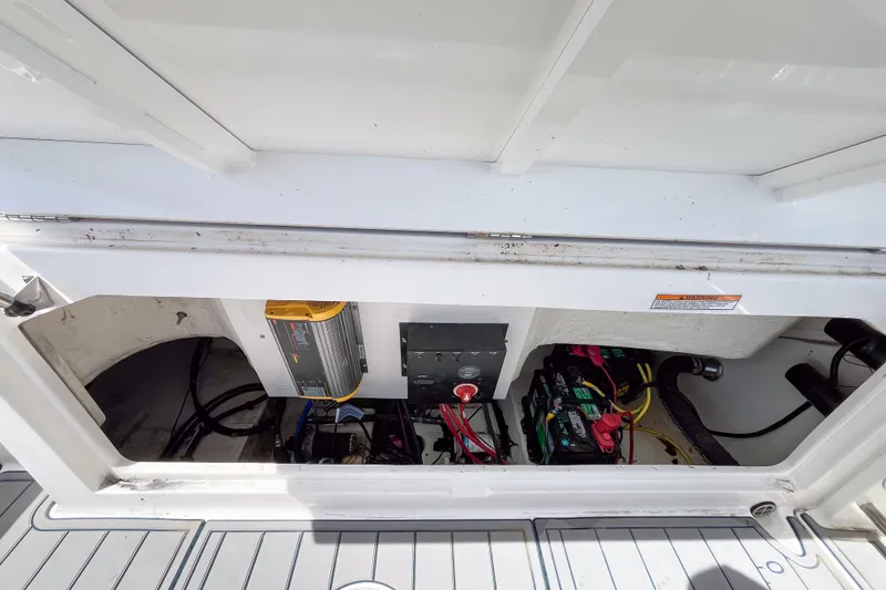 Slide: The Image of 2017 Robalo R222 Center Console boat battery compartment with wiring and components. - 4