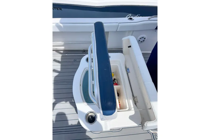 Slide: The Image of 2017 Robalo R222 Center Console boat with open storage compartment and cushioned seating. - 5