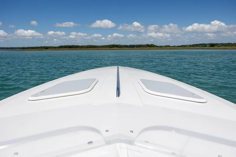 Slide: The Image of Bow view of 2014 Baja 35 Outlaw on calm water under blue sky. - 10