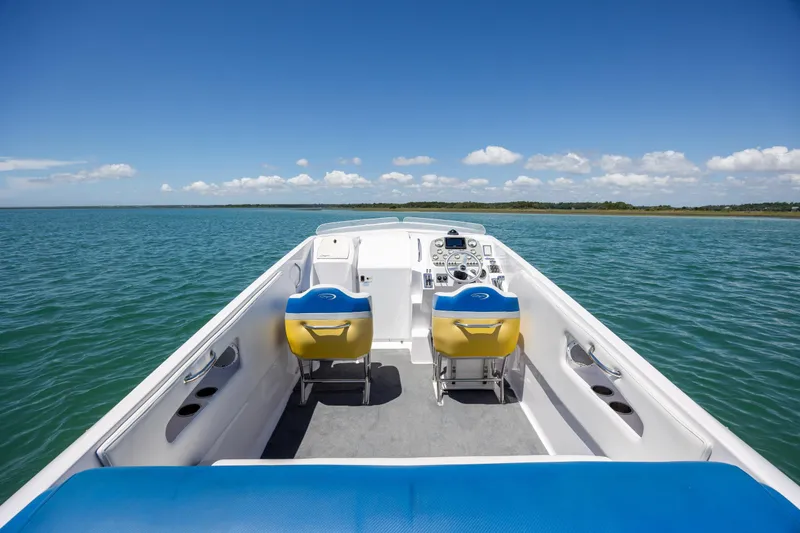 Slide: The Image of 2014 Baja 35 Outlaw boat interior on open water, clear sky background. - 12