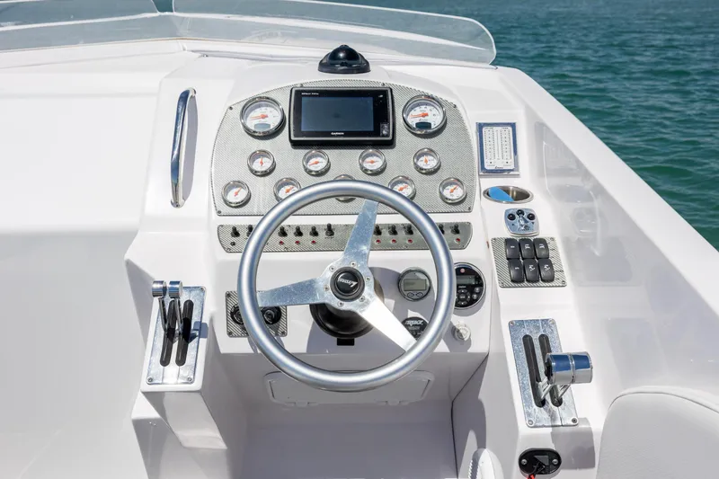 Slide: The Image of Dashboard of a 2014 Baja 35 Outlaw boat with steering wheel and gauges. - 16