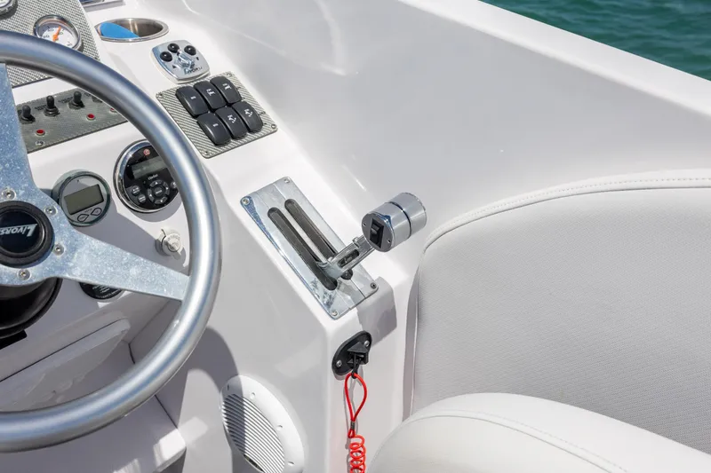 Slide: The Image of 2014 Baja 35 Outlaw boat cockpit with steering wheel and control panel. - 18