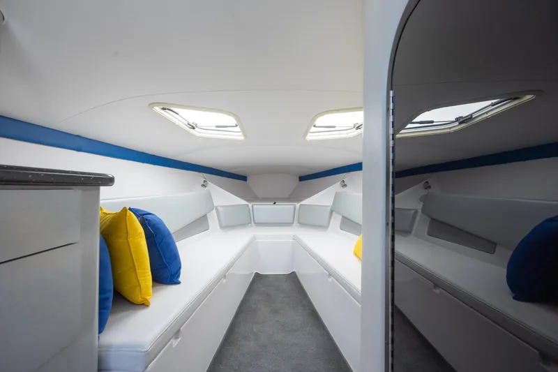 Slide: The Image of Interior cabin of 2014 Baja 35 Outlaw boat with colorful cushions. - 20