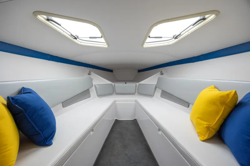 Slide: The Image of Interior cabin of 2014 Baja 35 Outlaw boat with colorful cushions and skylights. - 21